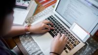 Student completing school work on her laptop at home