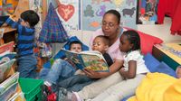 Preschool teacher reading to students