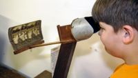 Student looking at photos in a history museum exhibit