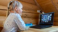 Elementary school student participating in a video chat with her class