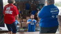 Volunteers sort and pack free books for low-income children