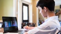 Teenage boy video chat with classmates