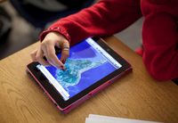 Student using a tablet to look at a map of South America