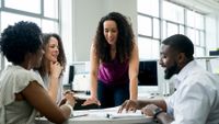 Four adults have meeting at work