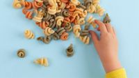 Child sorting dried pasta