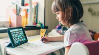 Young girl participating in class video chat during distance learning