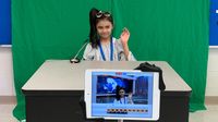 Girl student being a newscaster for class news program