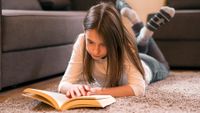 Girl reading book at home