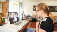 Middle grade aged girl distance learning on laptop at home
