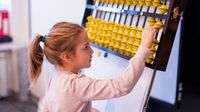 Elementary aged girl uses abacus at school