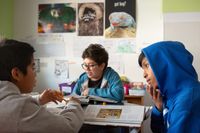 Middle school students discuss project in small group