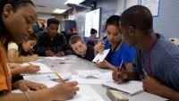 Physics teacher works with a small group of students