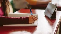 High school student writing in class