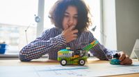 Boy tests a model car during remote learning