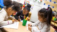 Preschool students work on an art project together in class