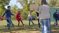 Third-grade students dance during an outdoor socially distanced music class. 
