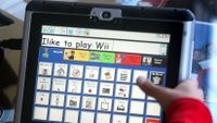 Child uses Dynavox alternative communication device