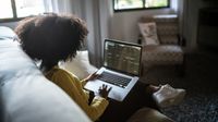 Teen looks at the calendar app on her laptop at home