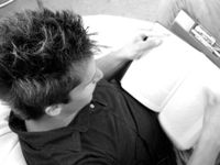 A person is sitting on a bean bag chair, reading.