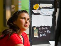 photo of a student in front of a presentation board about genius hour