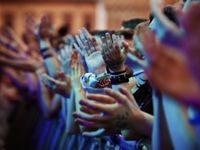Hands clapping in a large group of people