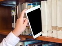 Hand pulling an iPad off the library shelf like a book