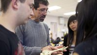 Teacher and three students looking at a human skeleton