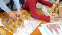 Kids build houses out of graham crackers in the author’s class.