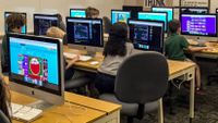 Kids in a classroom use a variety of programs to practice coding.