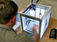 Man sitting setting up a design in the Ultimaker printer