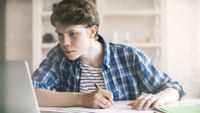 A boy does online research for an essay.