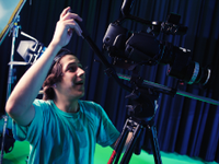 Boy filming using a very large camera