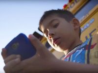 A child looks at a cell phone.