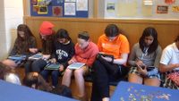 Girls play a math game on their iPads.