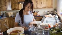 A teacher cooks in her kitchen for relaxation.