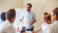 A group of teachers discuss a project.