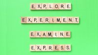 Scrabble tiles spell out powerful verbs.