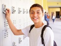 Boy at his locker outside hallway