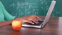 Photo of a teacher’s hands as she works at a computer