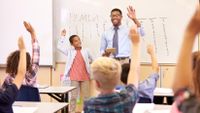 A teacher engages his students in a math lesson.