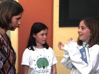 Teacher speaking with two students