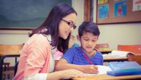 teacher working with student