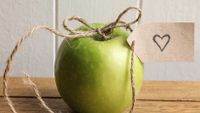 Photo of an apple with a bow on it.