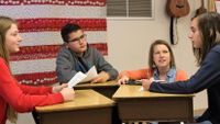 Katie Dulaney listens as her students have a discussion.