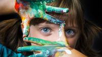 Photo of a girl with paint on both hands