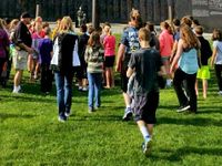 Students walking on a grassy field