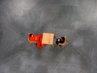 High, overhead view of two people sitting at a table on a patterned concrete floor with no one else around