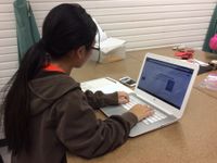 photo of a student working on a laptop