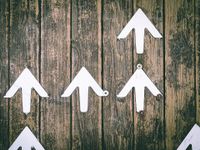 white graphic arrows on a series of wooden boards