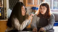 Two high school students working together in science class